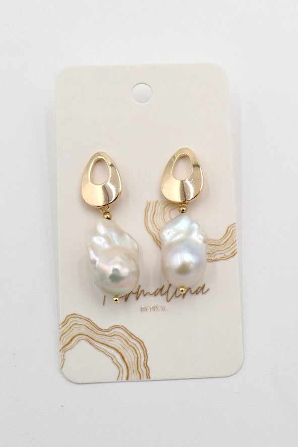 A pair of gold and baroque pearl drop earrings on a white display card with gold abstract line art and the brand name 'Personalised by Me' printed on it.
