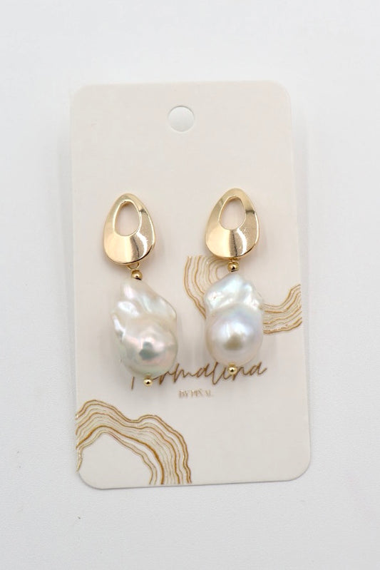 A pair of gold and baroque pearl drop earrings on a white display card with gold abstract line art and the brand name 'Personalised by Me' printed on it.